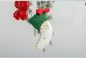 Close-up of handmade wool felt Christmas ornaments with star and mini stocking details