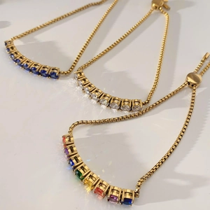 Detailed view of three gold-plated bracelets with adjustable sliders and round crystals