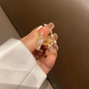 Delicate flower hair claw clip with pearlescent petals and a golden alloy base