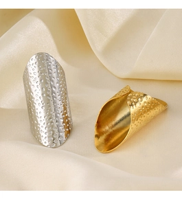 Macro shot of hammered metal texture on gold and silver vintage shield knuckle rings