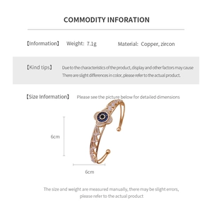 Detailed view of gold zircon flower open bangle with evil eye design and woven texture