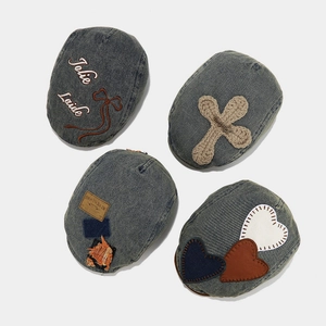 Vintage denim beret hats set featuring embroidery and leather patches on blue fabric