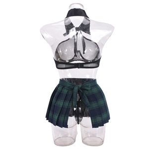 Detail of sheer black mesh top with bow and green plaid pleated schoolgirl skirt