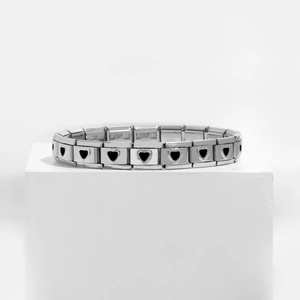 Detail view of stainless steel charm bracelet links with minimalist black heart patterns