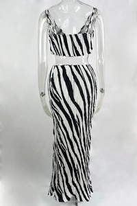 Detail of back view showing pleated texture and black-white stripe print on two-piece set