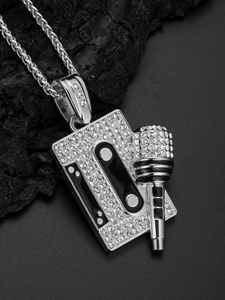 Close-up of silver hip hop cassette and microphone pendant with shiny rhinestones