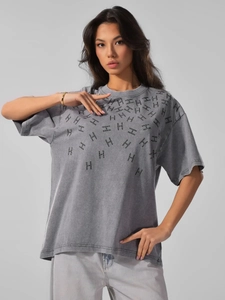 Close-up of vintage washed grey cotton t-shirt featuring H-shaped rhinestone pattern detail