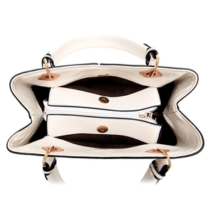 Interior view of beige leather handbag with multiple compartments and gold magnetic snaps