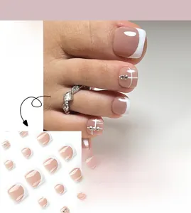 Detailed view of French white tip press-on toe nails with rhinestones and nude base