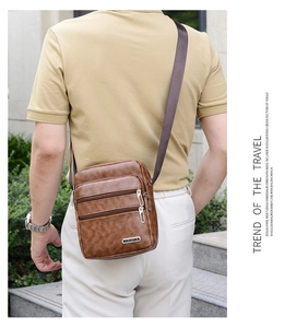 Detail of men's brown PU leather crossbody bag featuring triple zipper compartments and texture