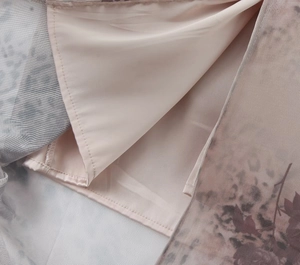 Detail of printed mesh fabric and smooth beige satin lining with neat stitching