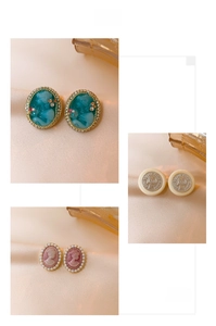Detailed views of vintage portrait earrings with emerald green accents and elegant pearls