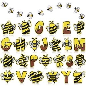 Macro shot of 26 embroidered bee alphabet patches showing detailed stitching and texture