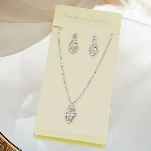 Detail of silver alloy jewelry set with marquise-cut zircons and rhinestone accents