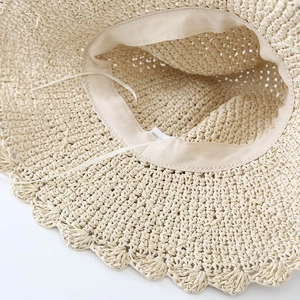 Detailed macro view of the interior sweatband and adjustable drawstring on a straw sun hat