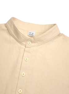 Close-up of linen shirt collar and buttons showing natural fabric texture and M size label