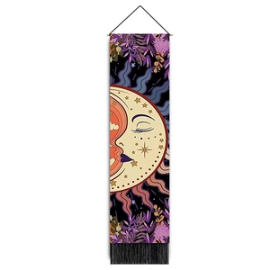 Close-up of sun and moon tapestry with gold star patterns and black fringe tassels