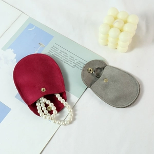 Microfiber velvet jewelry pouches in red and grey with snap buttons and pearl necklace detail