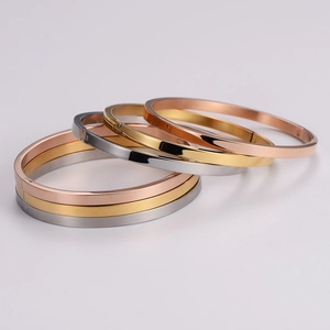 Minimalist polished stainless steel buckle bracelets in gold, silver, and rose gold colors
