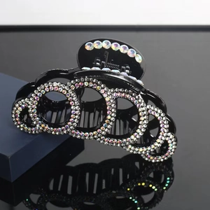 Classic large black hair claw clip with sparkling rhinestones in a circular pattern