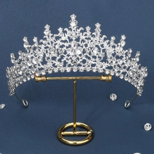 Macro detail of silver baroque bridal crown with crystals on a jewelry stand