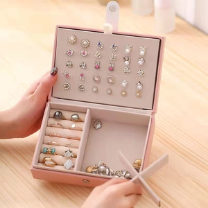 Pink leather jewelry box organizer with multiple compartments for rings and earrings