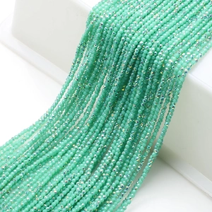 Detail view of faceted mint green glass beads arranged in elegant multi-strand cascades