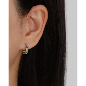 Close-up of s925 silver hoop earrings featuring green, blue, and purple zircon stones