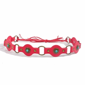 Detailed macro of red leather belt with turquoise stones and bronze ring accents