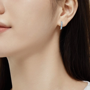 Close-up of model wearing S925 silver stud earrings with blue marquise cut zircon stones