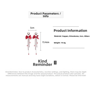 Detail view of red ribbon bow earrings with dimensions 5cm width and 15.4cm length