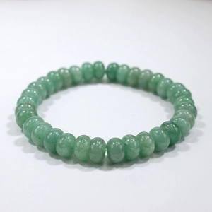 Detail of green natural stone beaded bracelet with polished round quartz beads
