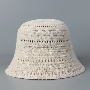 Close-up of beige breathable knit bucket hat showing hollow-out texture and mesh details