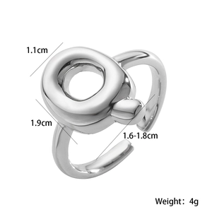 Detail view of silver irregular ring with height and width measurements on white background