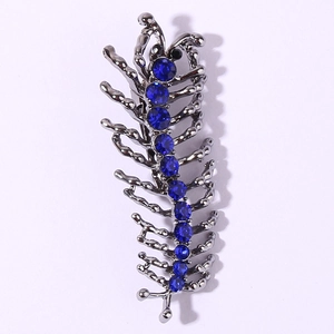 Gros plan d'une broche mille-pattes argentée avec strass bleus sur fond blanc