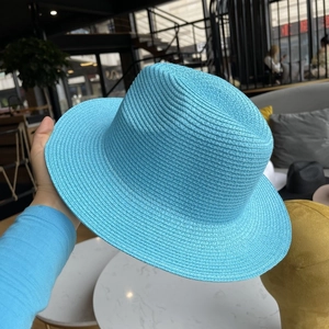 Close-up of bright blue woven straw fedora hat featuring fine textured texture details