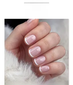 Detailed close-up of French tip short square press-on nails with white edges and pink base