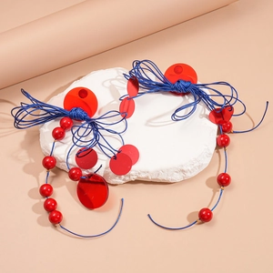 Ethnic style round resin earrings with red and blue tassels on white stone