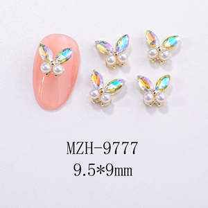 Macro view of 3D aurora butterfly nail art charms with white pearls in 9.5x9mm size