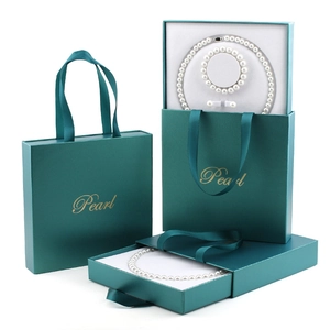 Three-piece pearl jewelry set in premium dark green gift box with matching carry bag