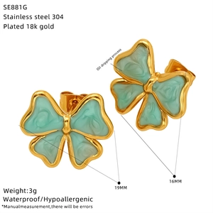 Detail of 18k gold plated stainless steel bow earrings with mint green oil dripping finish
