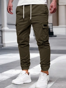 Detail of olive green cargo pants with drawstring waist and large side pockets