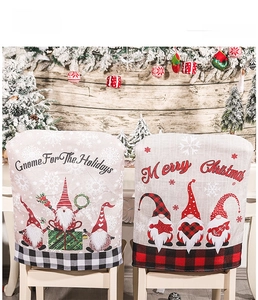 Detail of Christmas chair covers with festive gnomes and red black plaid borders