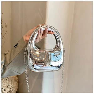 Close-up of silver liquid metal style acrylic handbag with chain strap and top handle