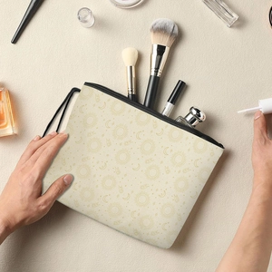 Canvas makeup bag with celestial sun and moon prints and black zipper closure