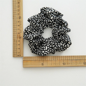 Vintage leopard print scrunchie in black and white fabric with size measurements
