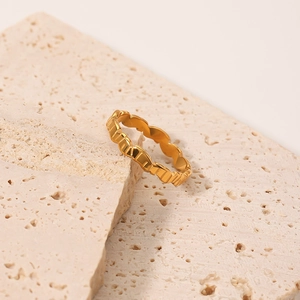Minimalist irregular gold stainless steel ring featuring a wavy geometric texture
