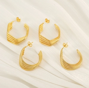 Detail of 18k gold plated stainless steel hoop earrings with woven rope texture