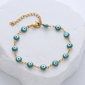 Close-up of gold stainless steel evil eye bracelet with blue enamel beads and lobster clasp