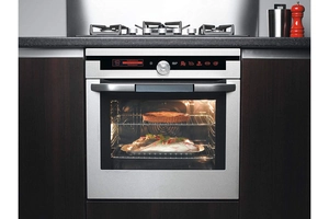 Modern built-in stainless steel oven with dual-layer cooking and LED display panel
